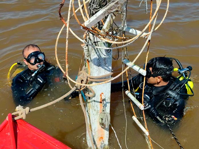 Mergulhadores checam se há vítimas dentro de barco naufragado